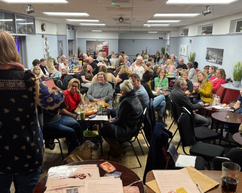 Shows how ell attended the March 2025 Quiz Night was with large room filled with people sat at tables having a fun evening.
