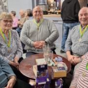 The 5 members of the winning Quiz Night team with big smiles and first place medallions